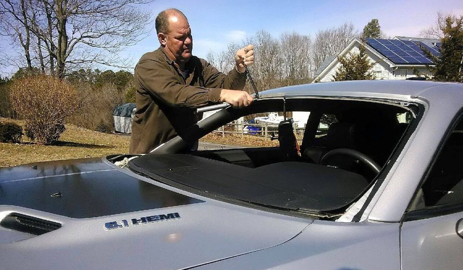 photo of man removing glass from car